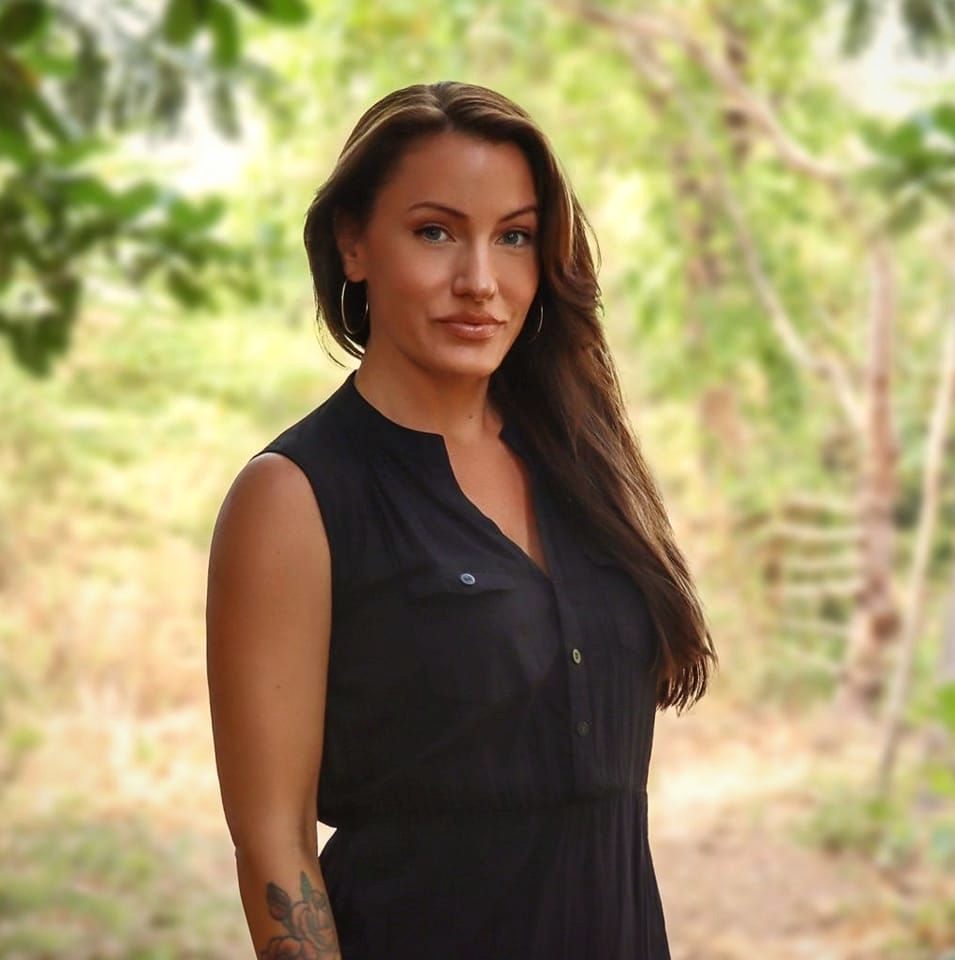 Portrait of Hilde Marie Kvaløsæter standing outdoors among trees